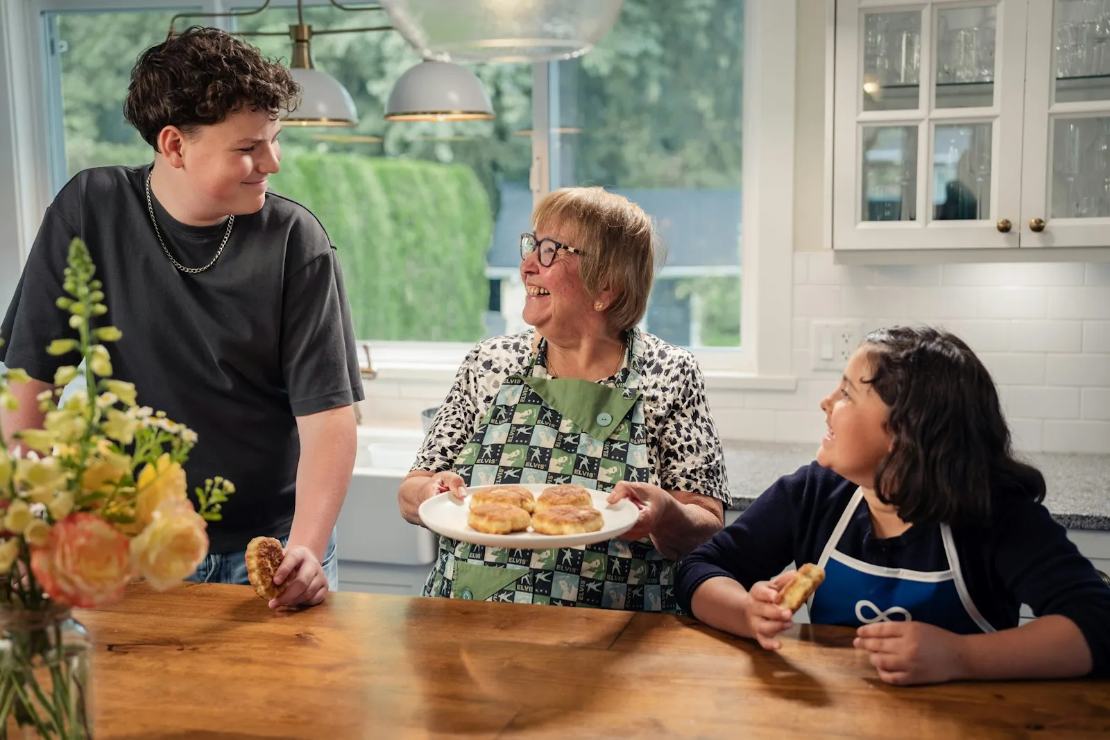 A smiling grandmother sharing homemade treats with her grandchildren