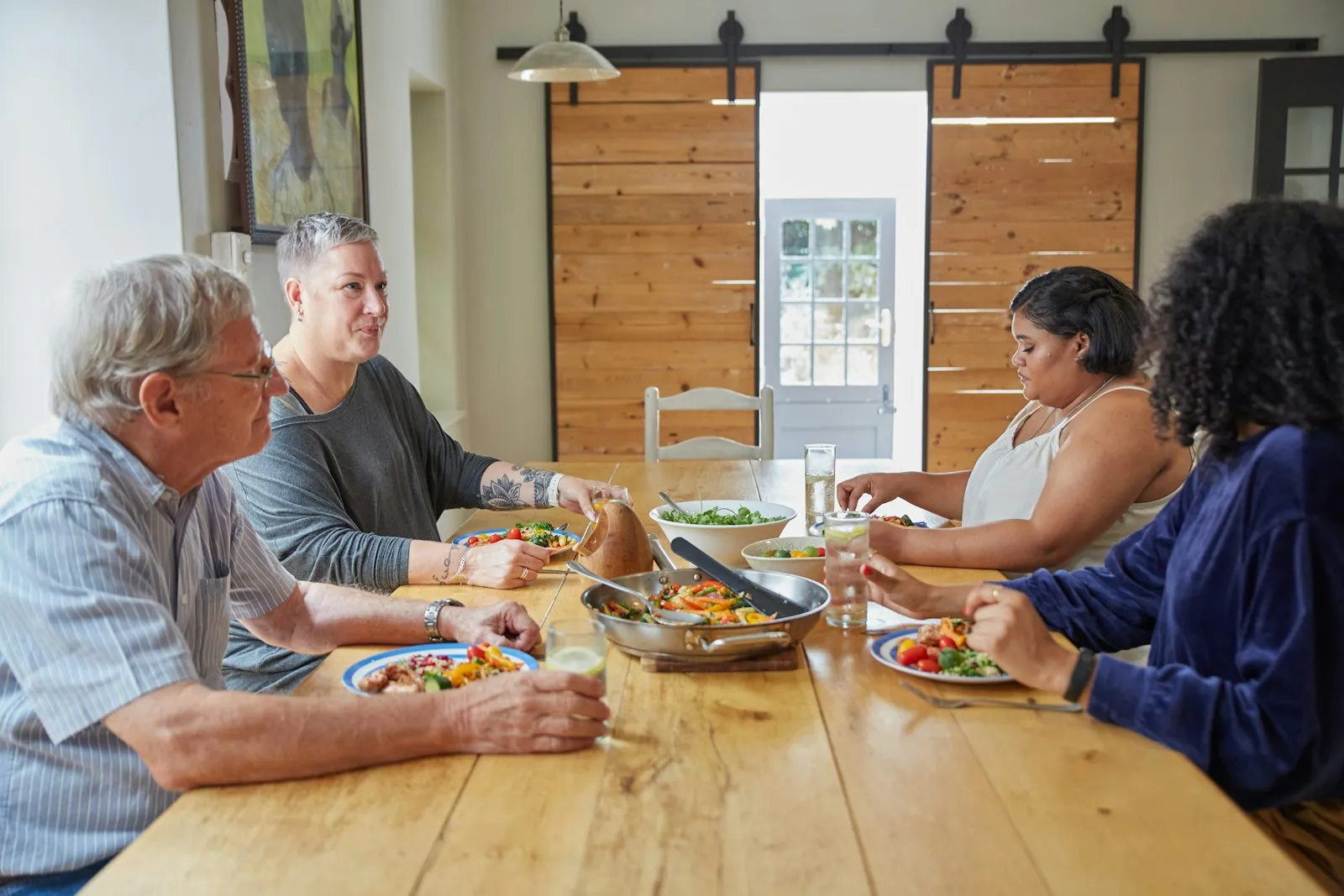 Friends sharing supper around a long wooden table